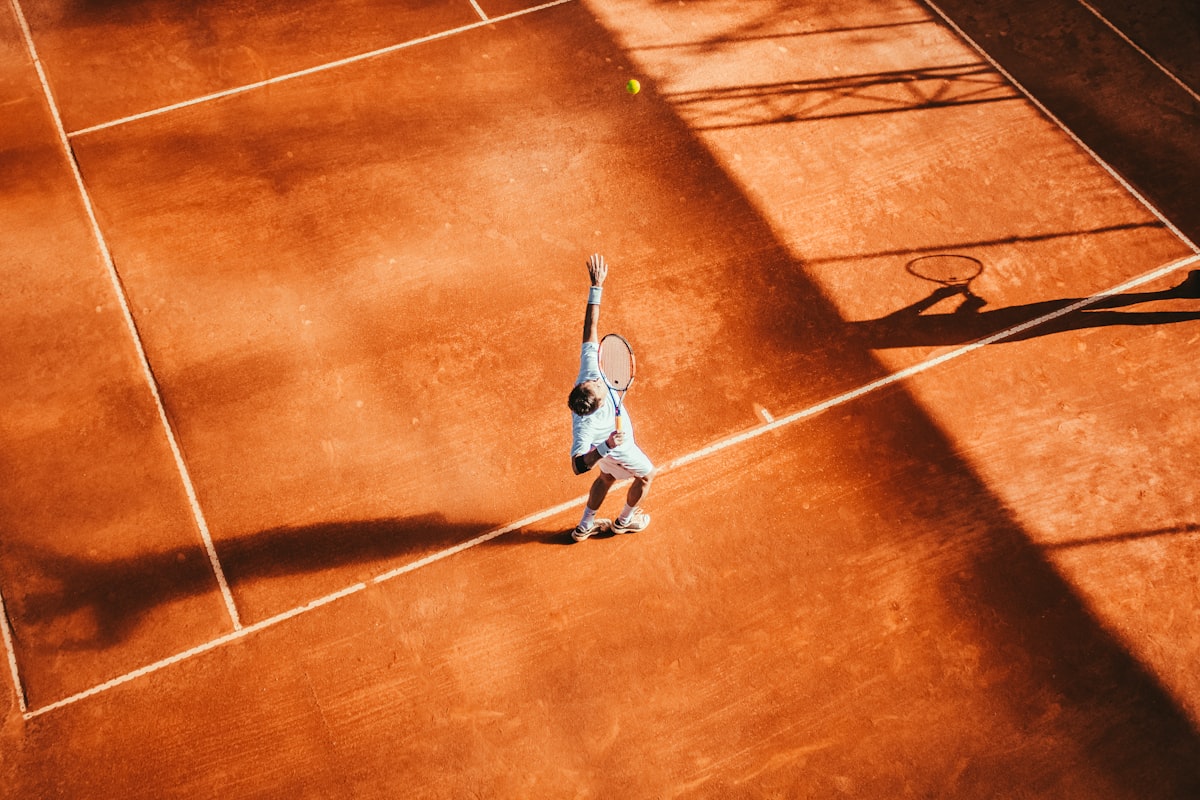 A tennis ball curves through the air under the influence of spin